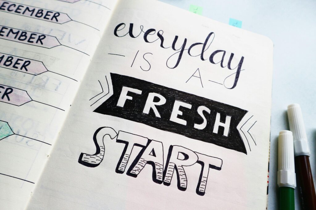pexels-photo-636243-636243 Notebook page featuring motivational quote 'Everyday is a fresh start' with colorful pens.